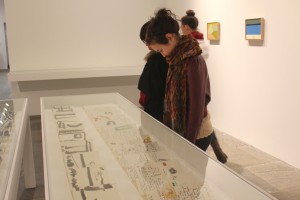 Second year BFA, Melody Stein looks at some of the works on paper displayed in the show. Photo by Danni Shen.
