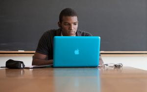 A student working on a laptop.