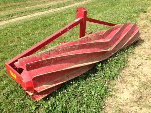 Implement used to crimp and roll down cereal crops for mulch