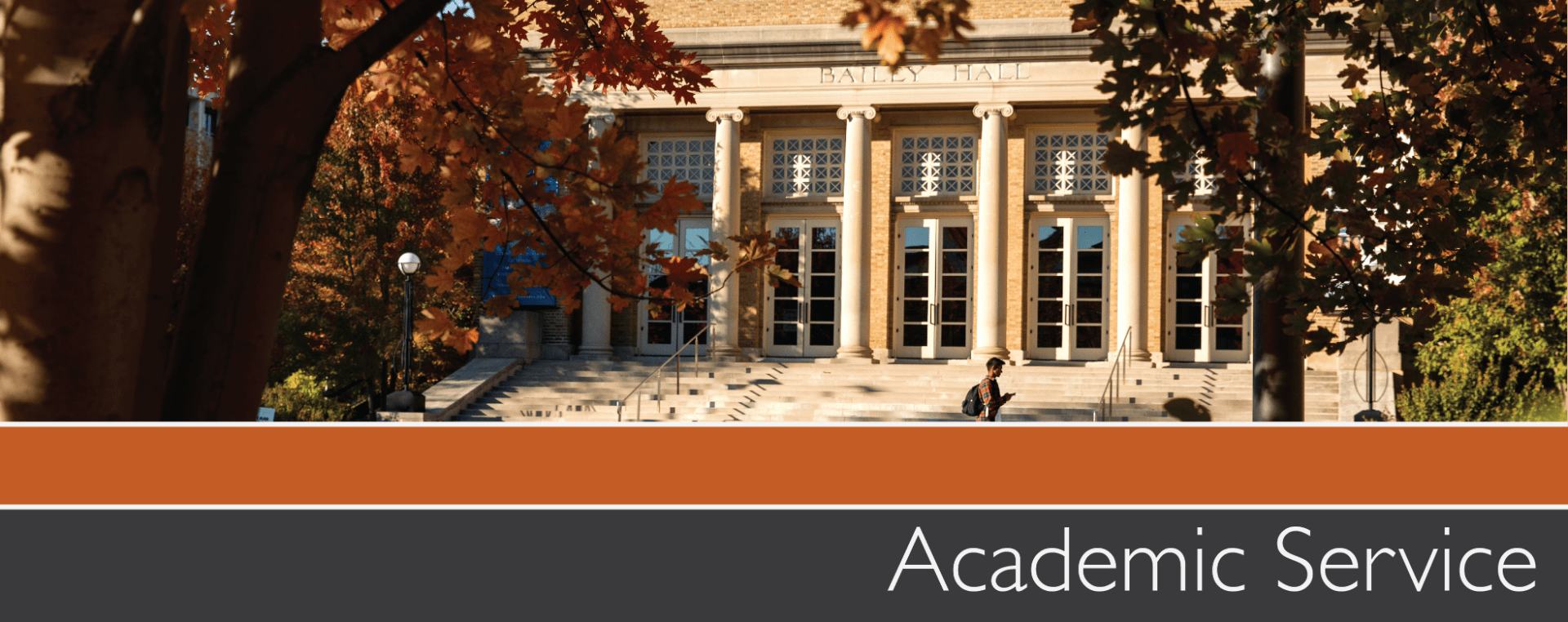 Banner with a photo of the front of a building with columns in fall with text underneath that reads academic service.