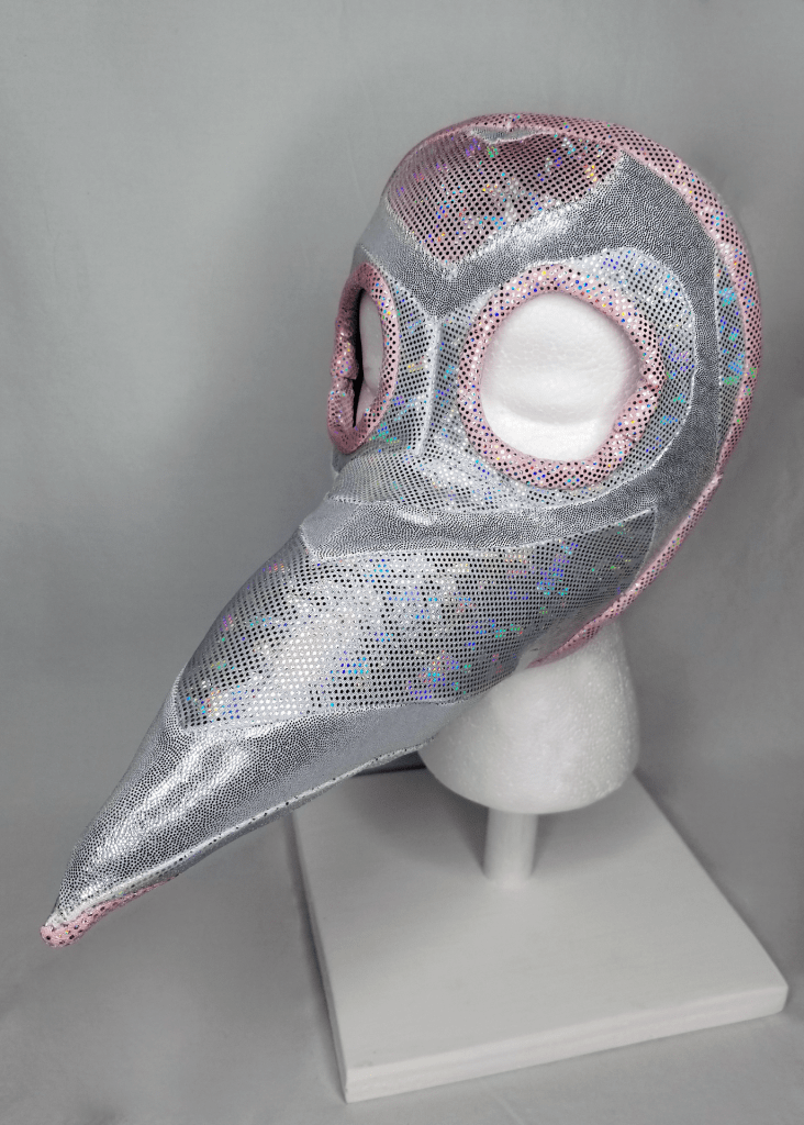 A silver and pink beaked mask