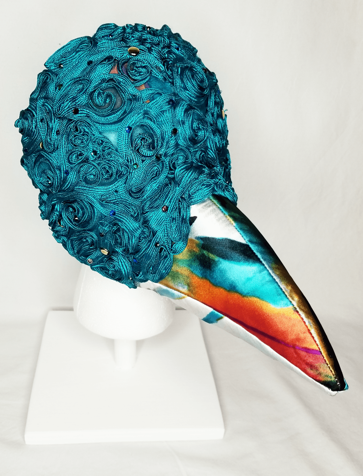 A beaked mask with teal detail
