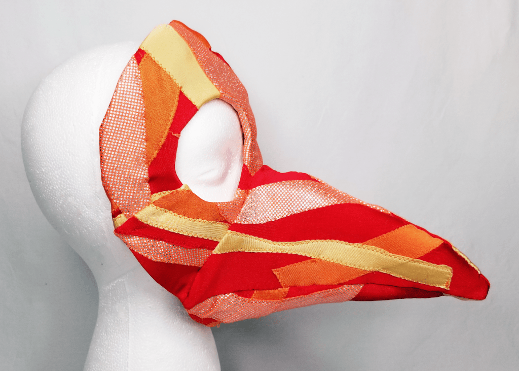 A red, orange, and yellow beaked mask