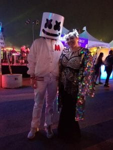 Two people in fanciful costume with headpieces