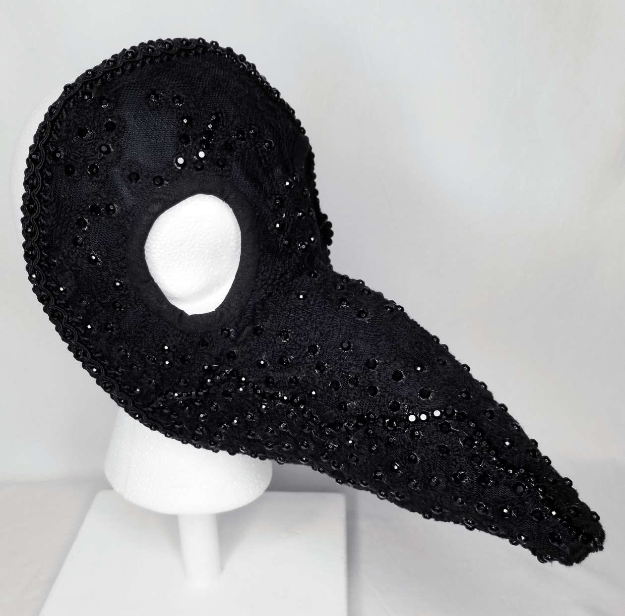A black embellished beaked mask