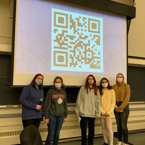 students in FGSS 2010 standing in front of a projected QR code that leads to their website.