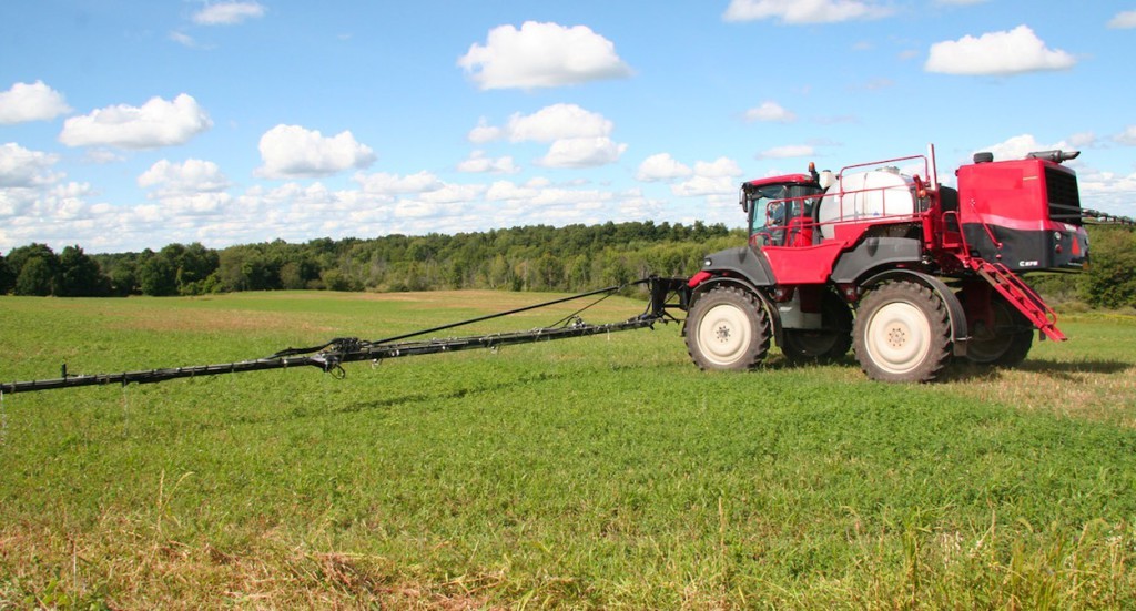 Applying biocontrol nematodes to an alfalfa field in northern NY. Adapted ATVs and other on-farm equipment are also used to apply the combination of two native NY species of nematodes that NNYADP-funded research has proven can successfully reduce alfalfa snout beetle populations. Photo: NNYADP