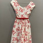 This image is of a white dress with the word "IKE" written all over it in large, red letters.