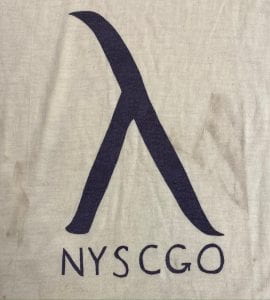 Close-up of silk screened t-shirt with black Lambda and "NYSCGO." 