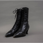 Black heeled boot. Leather. Laces up front.