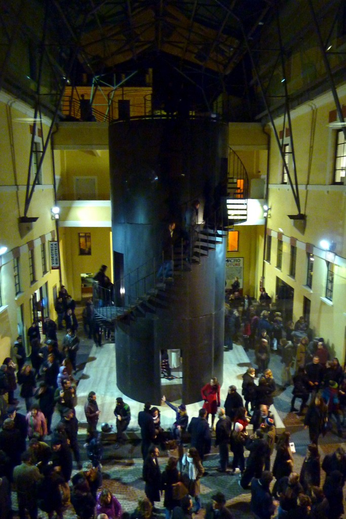 Tower art installation surrounded by people at MACRO's opening.