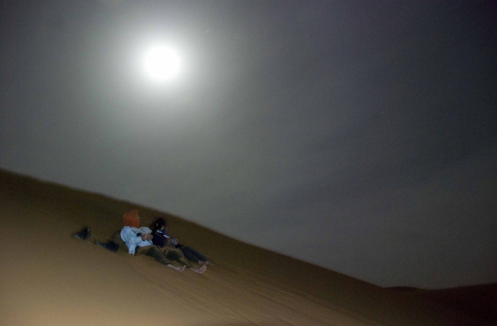 Climbing up a massive sand dune in the middle of the night