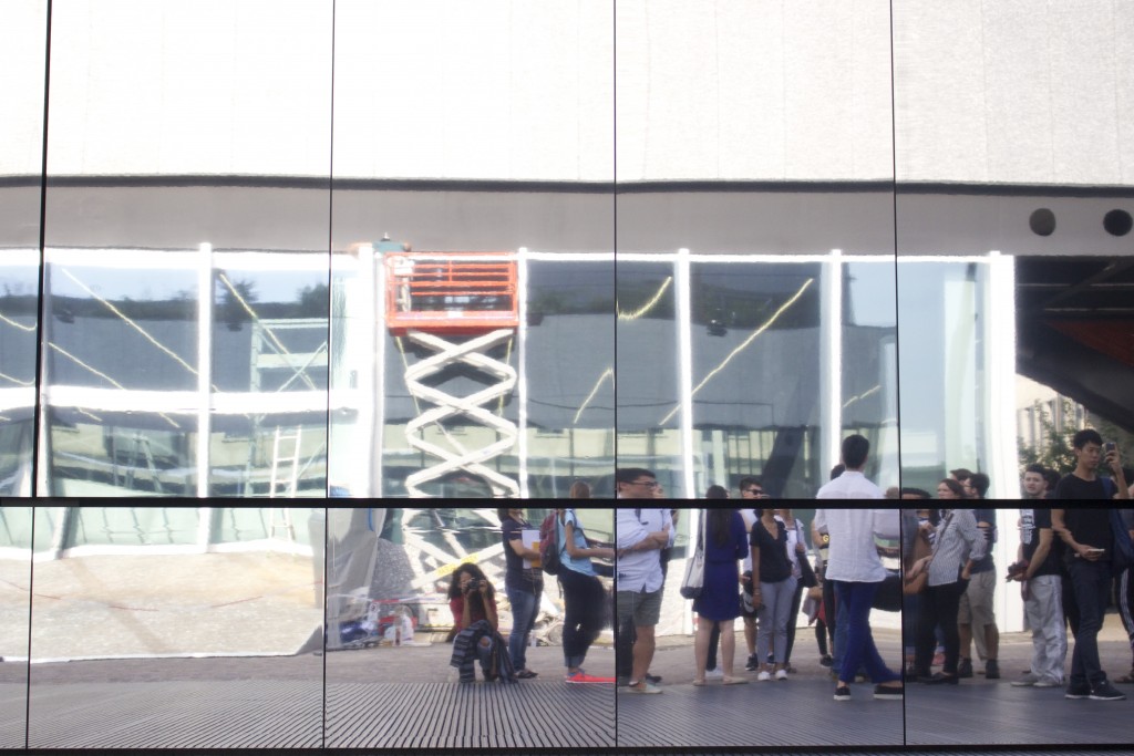 Students stand in front of mirrored auditorium.  Photo by Michaela Delasanta