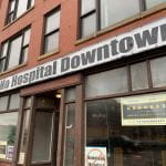 Building emblazoned with a "No Hospital Downtown" sign