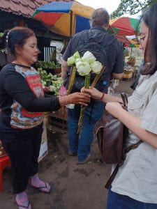 student getting lotus flowers