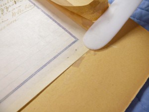 Staples had been used to hold the document to the backing board.