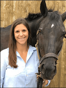 Rosenbaum in a headshot posing next to a horse