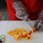 food service hands cutting peaches CCE Widen