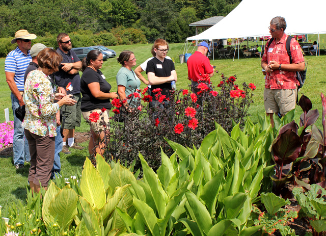 Bill Miller (right) talks about uses of summer bulbs -- such as dahlias and cannas.