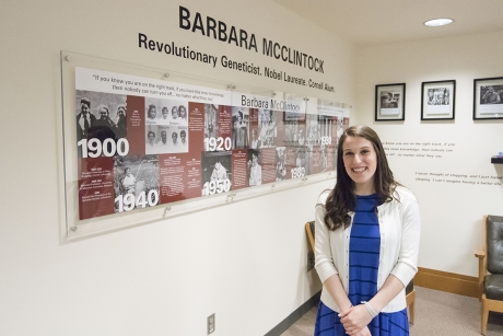 Juliet Jacobson ’16 stands in front of the exhibit she designed for Nobel laureate Barbara McClintock in Mann Library. (Photo: Matt Hayes)