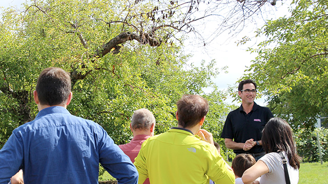 Assistant professor Greg Peck began the orchard tour in front of historic 100-year-old trees.