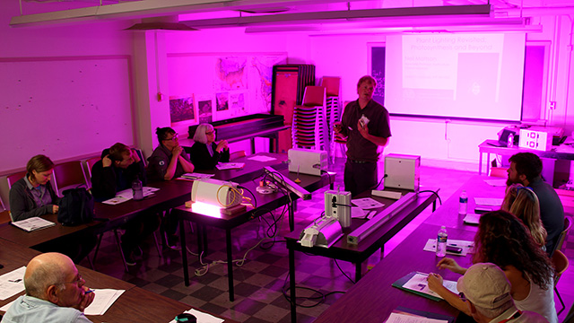 Horticulture associate professor Neil Mattson demonstrates the latest in greenhouse lighting systems at the greenhouse workshop.
