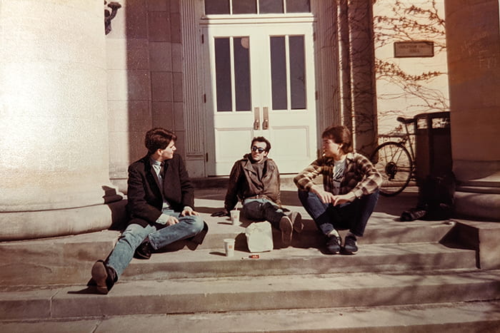 Three members of the LGBT Coalition (1990s) sit outside Goldwin Smith Hall eating lunch.