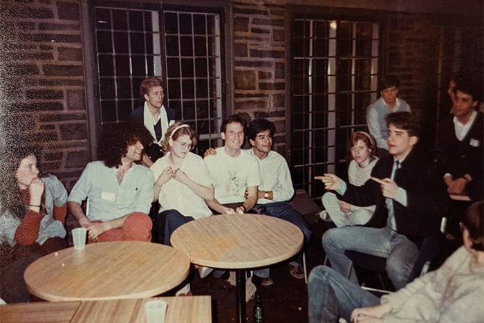 Members of the LGBT Coalition (1990s) gather inside Willard Straight Hall for a club meeting. This spot is now an eatery, “Straight from the Market.”