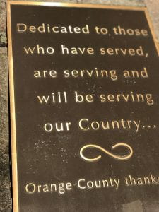 Plaque with the following words: Dedicated to those who have served, are serving and will be servinf our Country - Orange COunty thanks...(words cut off) 