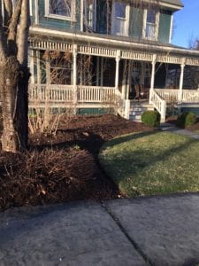 Freshly mulched garden bed in front of a house