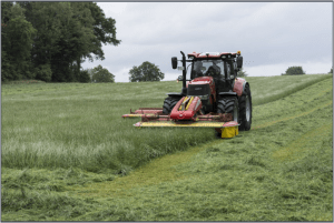 Tractor mowing a hay field