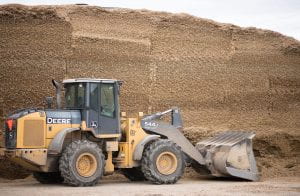 A loader in front of a feed bunk.