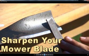 mower blade being sharpened with a file