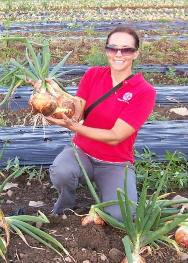 Photo shows Christy Hoepting in an onion field.