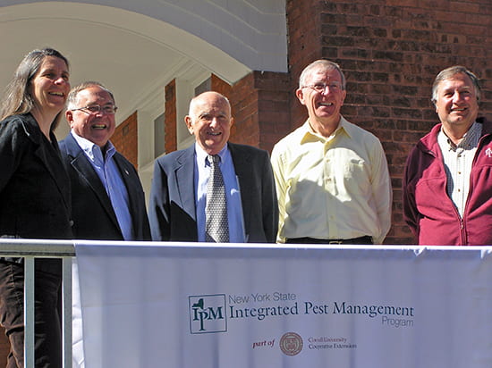 photo of five past and present IPM directors on porch of IPM house