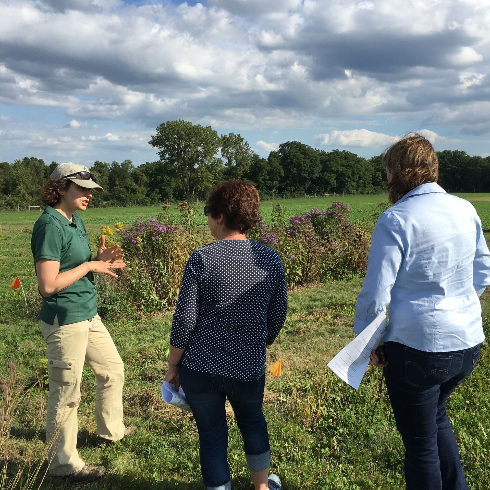 photo of Amara with cooperative extension staff at the beneficial habitat plot field day
