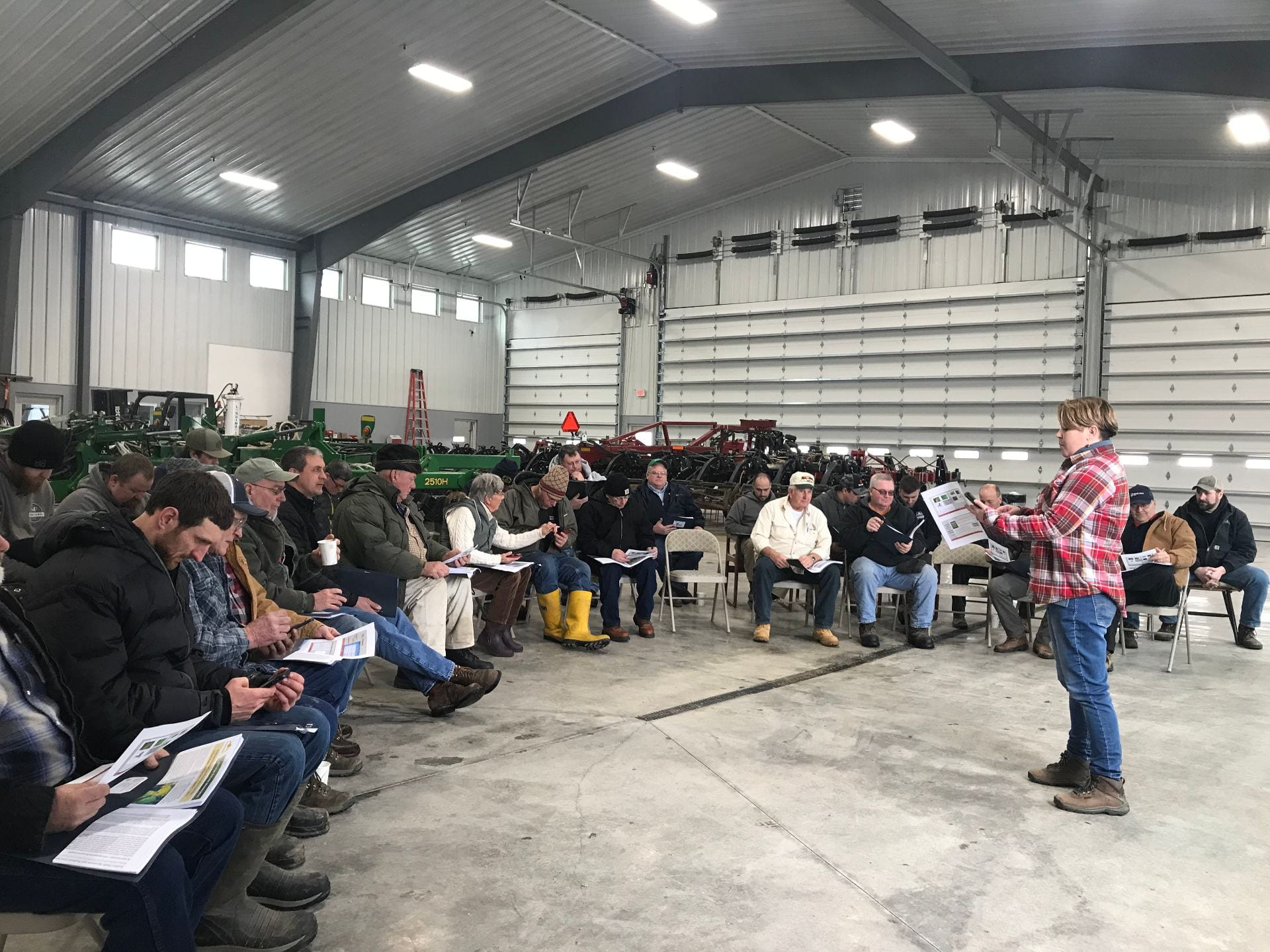 Photo shows New York State Integrated Pest Management Program's Jaime Cummings speaks to a group of soybean farmers about soybean diseases.