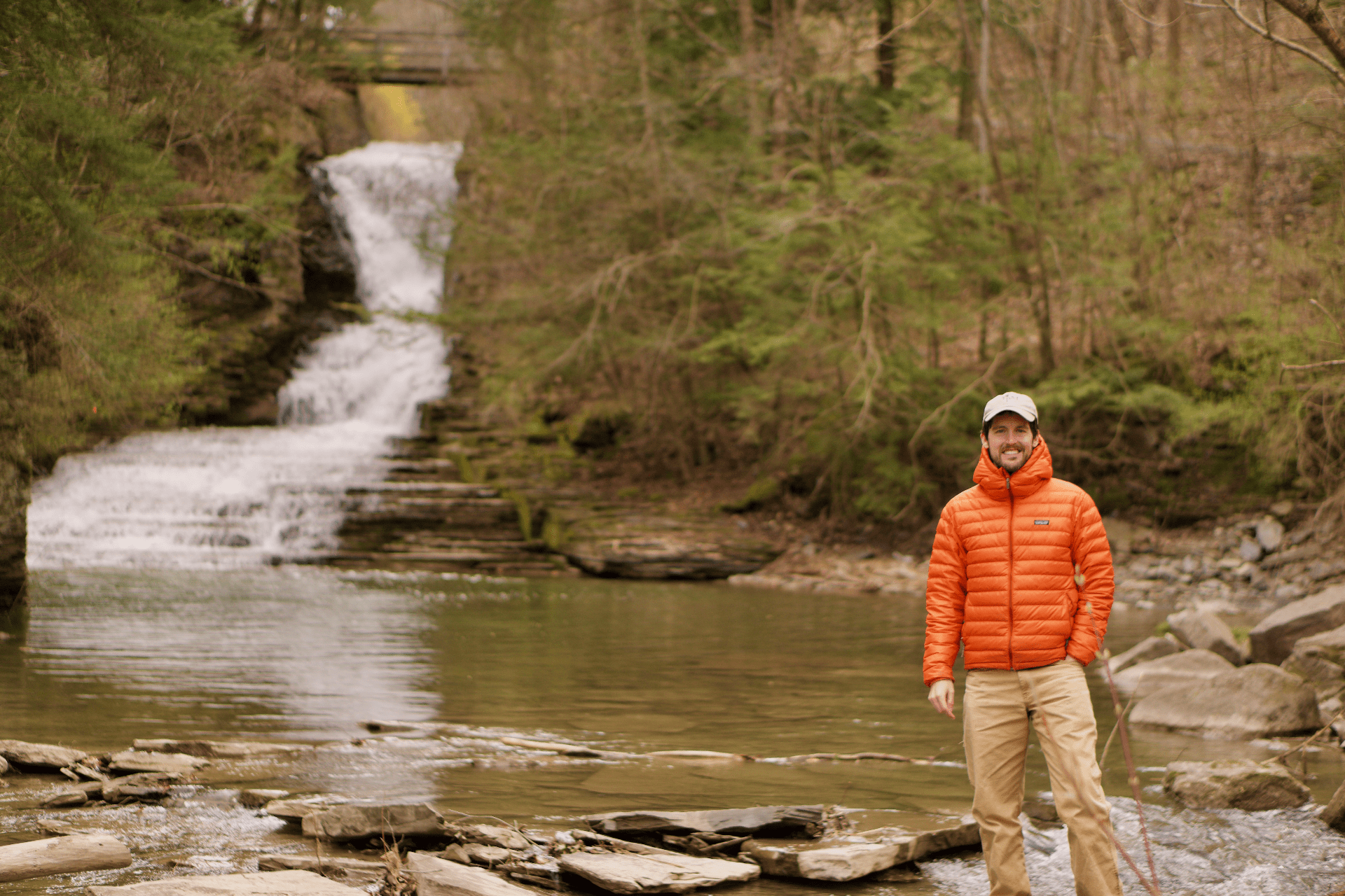 photo of Bryan Brown standing near a small waterfall in upstate new york