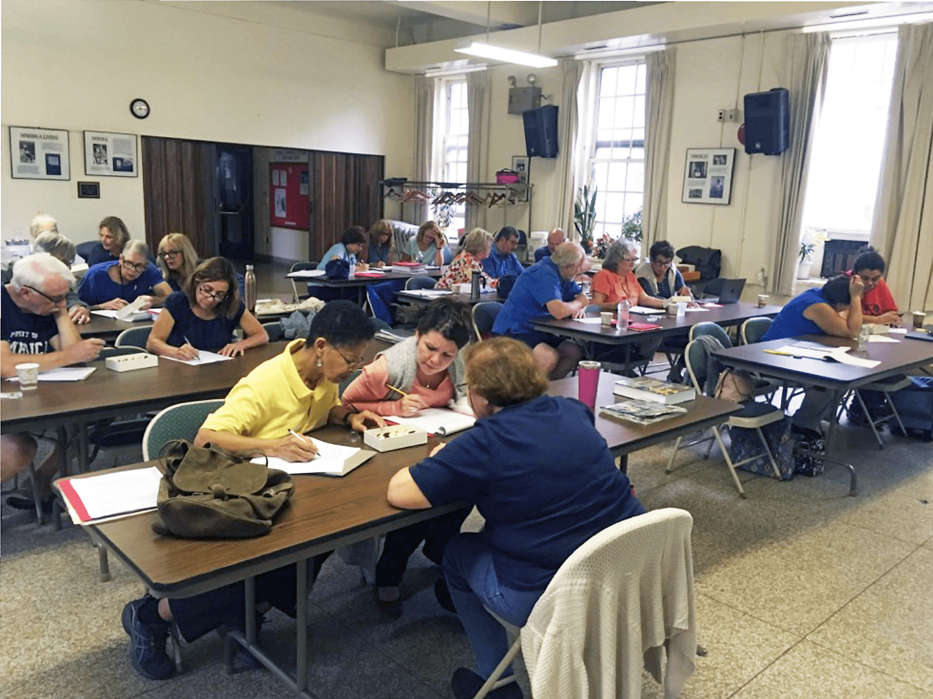 photo shows a classroom setting where master gardeners are learning to ideinty pests