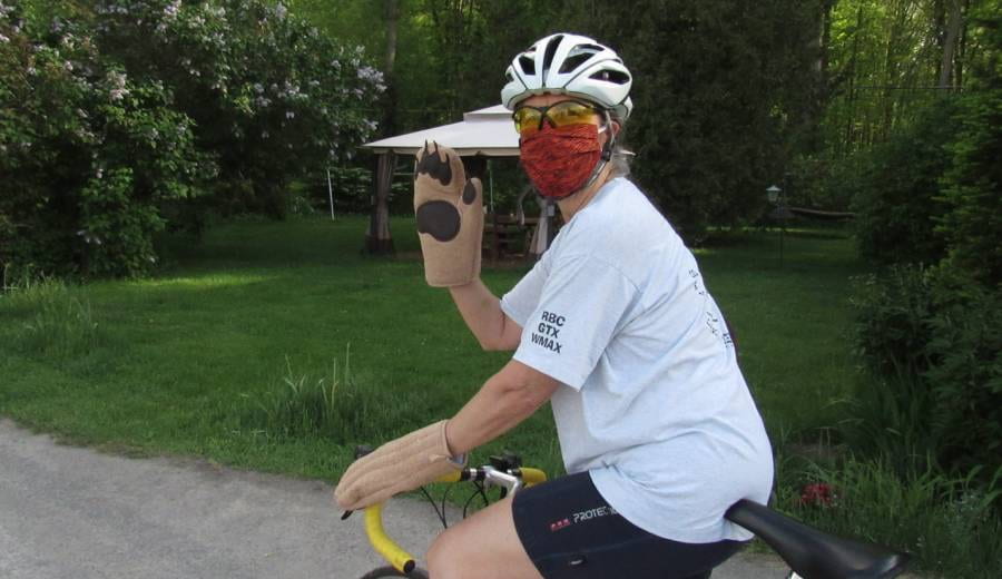 photo of Jen on a bike with mask and bear gloves