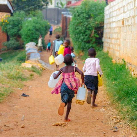 children carrying water cans