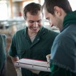 Veterinarians record research data in notebook