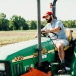 Farm worker driving a tractor