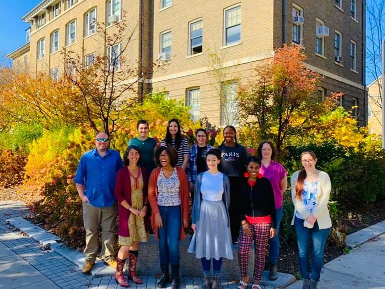 members of the specht lab gathered outside and facing the camera