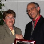Bruce Reisch receiving Outstanding Accomplishments in Applied Research award from Kathryn Boor.