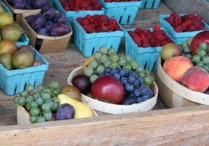 A picture of summer fruits on display at a farm market.