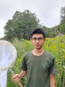 PhD student, Gen-Chang holding an insect net