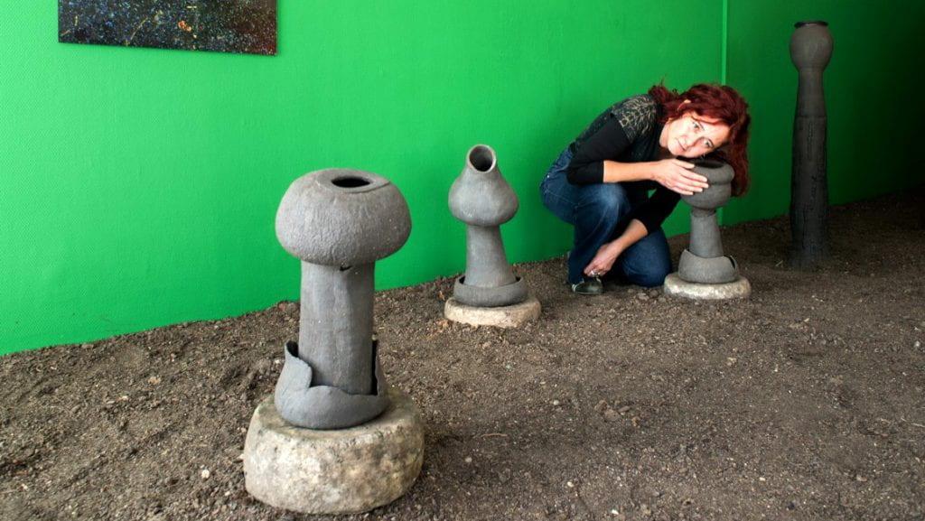 Karine Bonneval with sculptures for her project “Listen to the Soil” (“Ecouter la terre”)