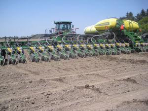 Planting grain corn with a new 20” corn planter in 2013, one of the many new planters purchased in the last few years by corn growers, greatly stimulating the agricultural equipment industry in upstate NY.