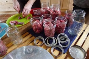 meat cutting and filling jars